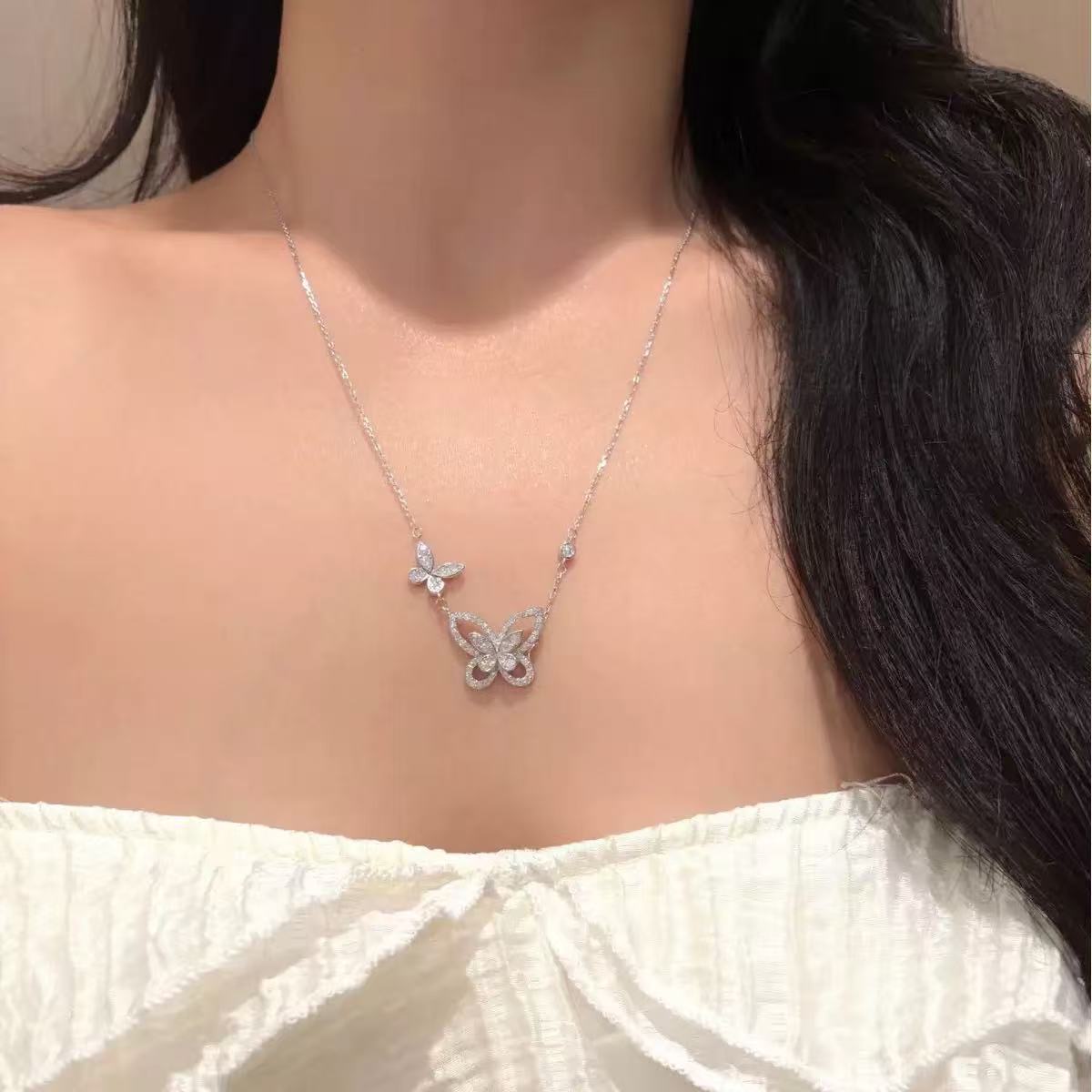 Double butterfly moissanite necklace worn by model